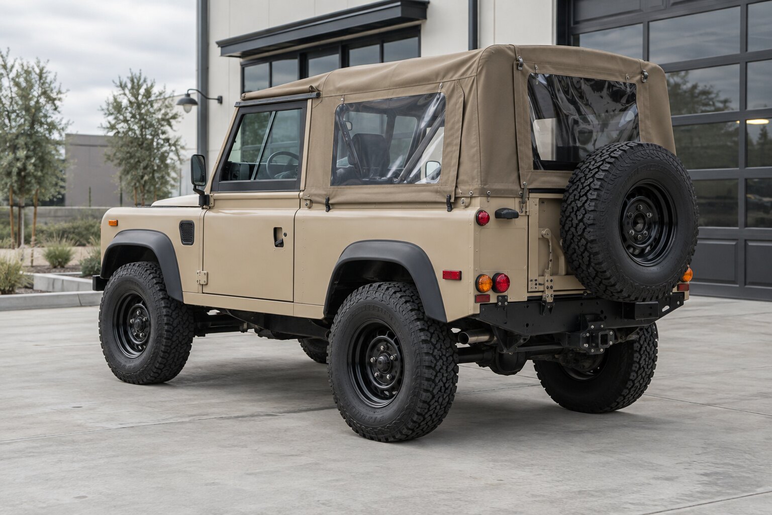 Illustrative rear three-quarter angle showing a tan SUV’s rear, side, roof, and wheels